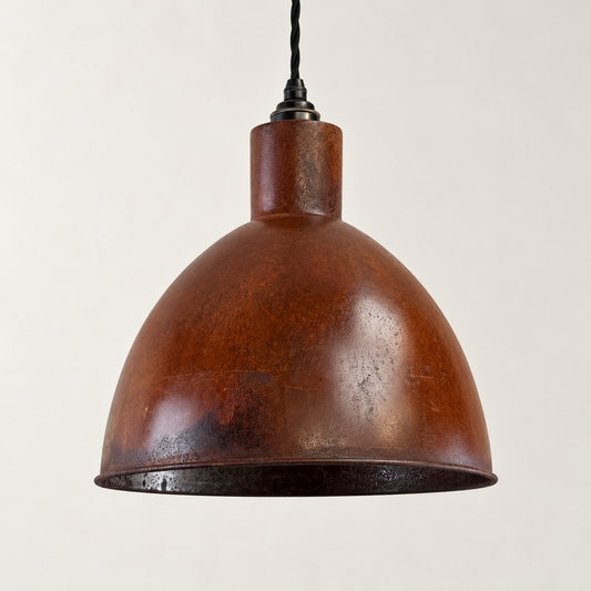 Warham rusted steel pendant light with black twisted cable on a warm off-white studio background