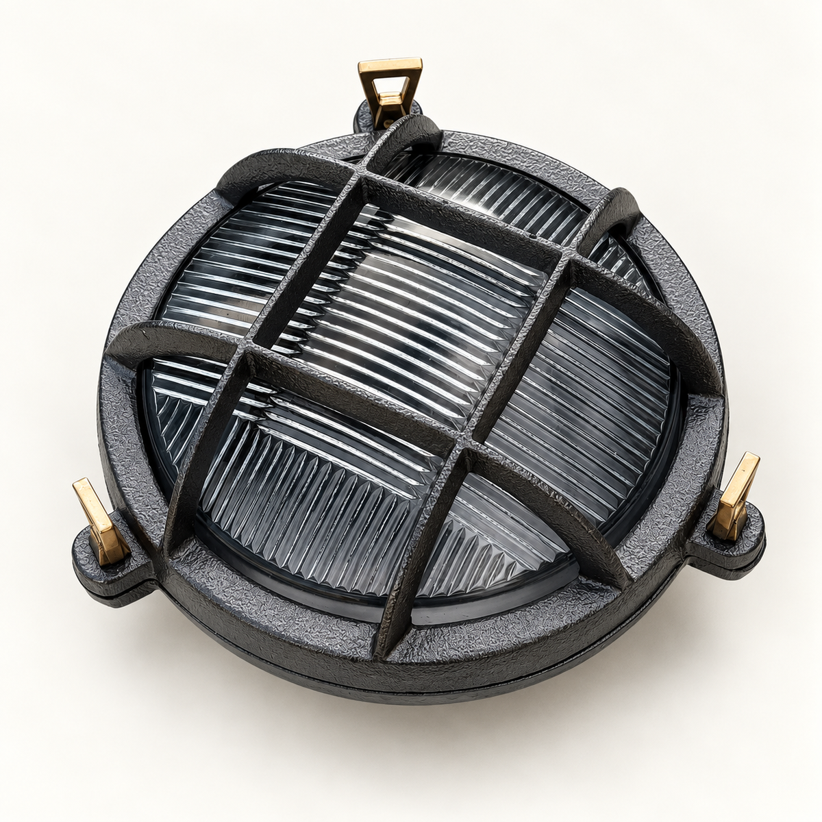 A round dark grey cast-iron outdoor light fixture with a protective cross-bar grille and brass mounting hardware, shown on a clean off-white background.