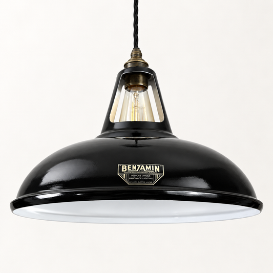 A black metal pendant light with a white enamel diffuser inside the dome shade, featuring a brass-toned neck and a vintage-style BENJAMIN brand plaque on the front.