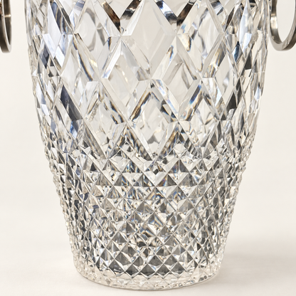 A close-up of a clear cut-crystal or glass bucket with a diamond-patterned faceted design and silver-tone metal handles visible at the top edges, set against a clean white background.