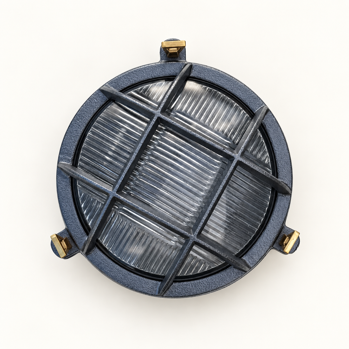 A round outdoor light fixture with a textured dark gray cast metal frame, a clear ribbed glass lens, and brass mounting hardware, shown from a top-down perspective on a white background.