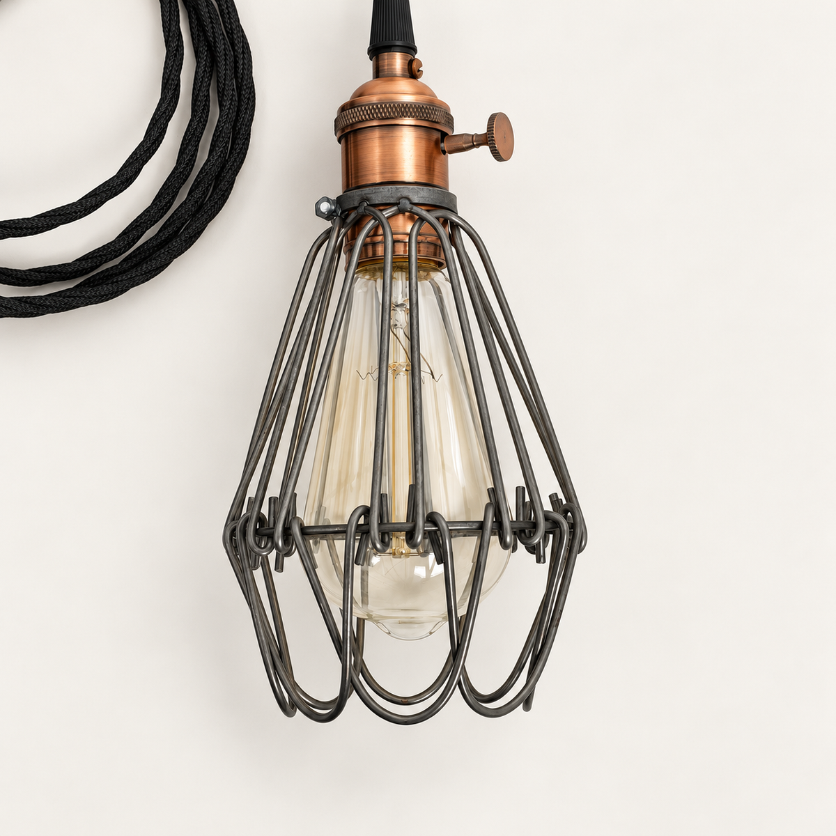 Close-up of the Hemsby lamp copper finish holder, side rotary switch, raw steel cage and unlit Edison bulb
