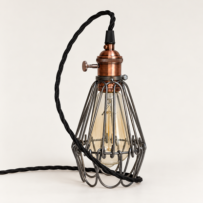 Hemsby raw steel cage table lamp with copper finish holder and black twisted fabric cable, bulb off