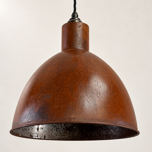 Warham rusted steel pendant shade, close-up on a warm off-white studio background